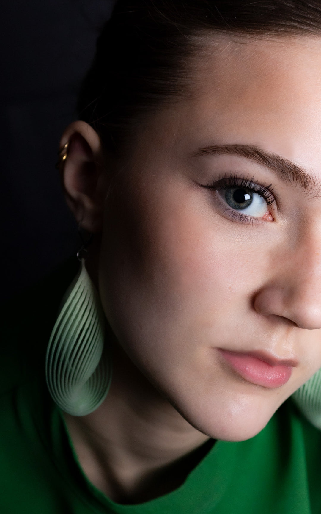 Portrait d’une femme portant les boucles d’oreilles OASIS vert sauge ultralégères en nylon recyclé imprimé 3D par Vox & Oz